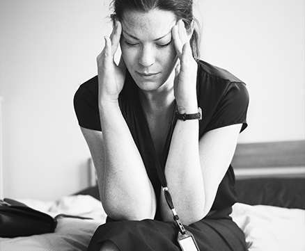 Person sitting cross-legged on couch, hands resting calmly on knees