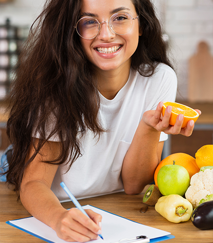 Hands chopping colorful vegetables on wooden cutting board in home kitchen